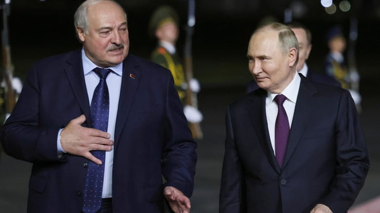 Russian President Vladimir Putin, right, listens to Belarusian President Alexander...