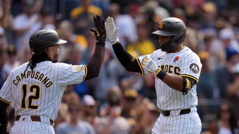 San Diego Padres' Donovan Solano, right, celebrates with teammate Luis...