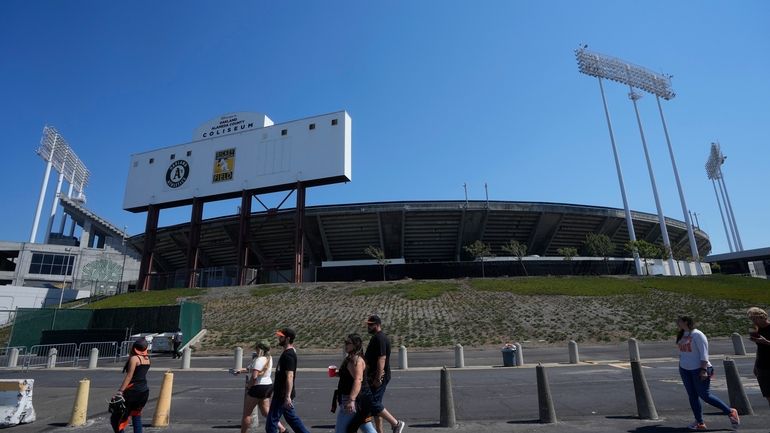 Fans walk outside of the Oakland Alameda Coliseum before a...