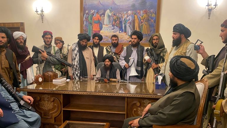 Taliban fighters take control of the Afghan presidential palace after...