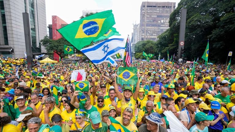 Followers of former Brazilian President Jair Bolsonaro rally to express...