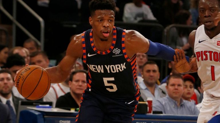 Dennis Smith Jr. #5 of the New York Knicks controls...