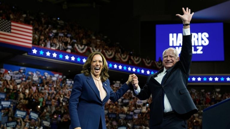 Democratic presidential nominee Vice President Kamala Harris accompanied, left, by...