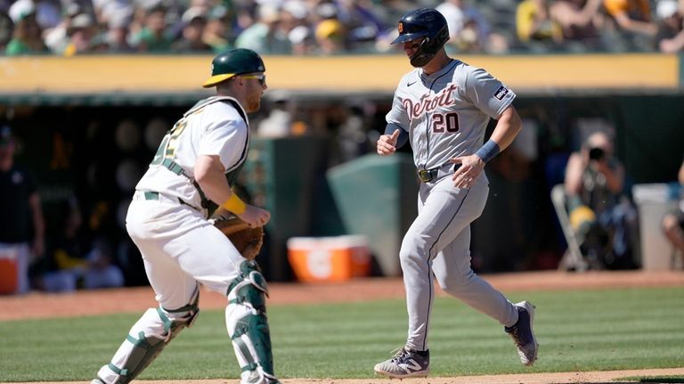 Detroit Tigers' Spencer Torkelson (20) scores a run past Oakland...