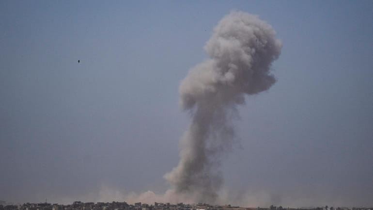 Smoke billows after an explosion in the Gaza Strip, as...