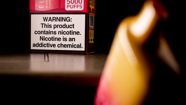 A health warning is seen on the packaging of a...
