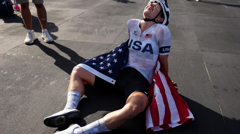 Kristen Faulkner, of the United States, celebrates winning the women's...