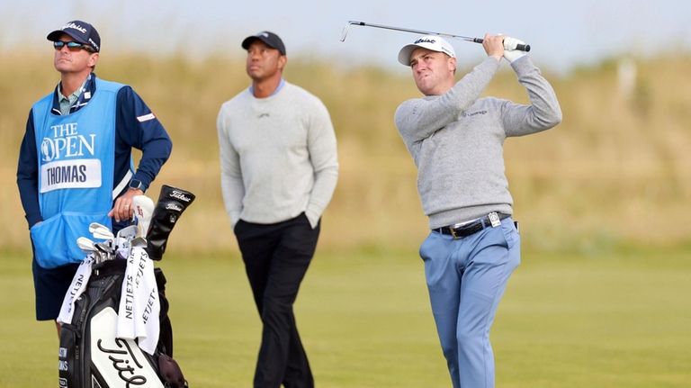 Tiger Woods, center, watches US golfer Justin Thomas, right, during...