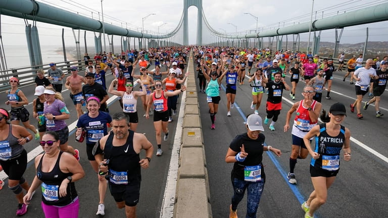 Runners cross the Verrazzano-Narrows Bridge at the start of the...