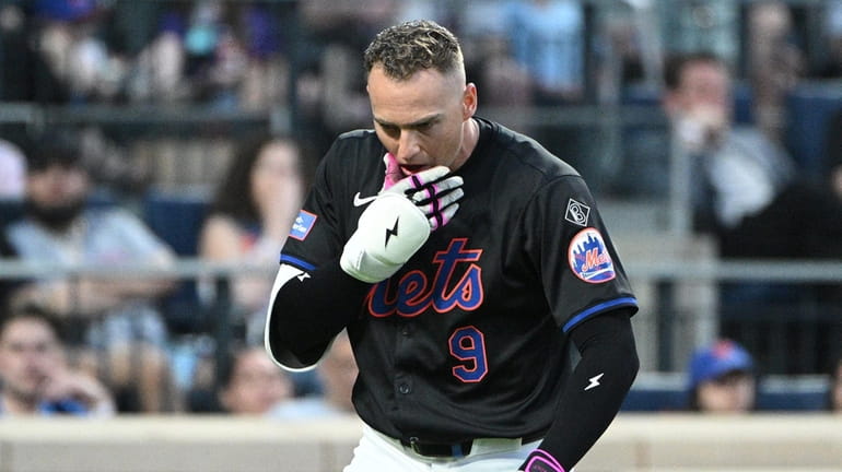 New York Mets’ Brandon Nimmo reacts after being hit by...