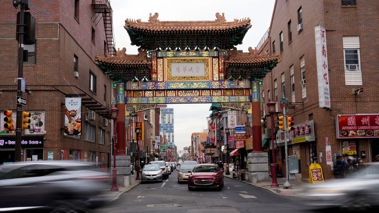 Evening traffic passes near the Chinatown neighborhood of Philadelphia, Wednesday,...