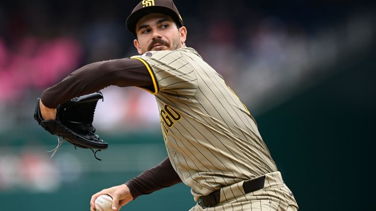 San Diego Padres starting pitcher Dylan Cease winds up to...