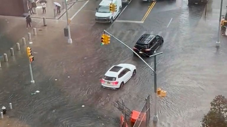 Vehicles including a school bus try to maneuver on a...