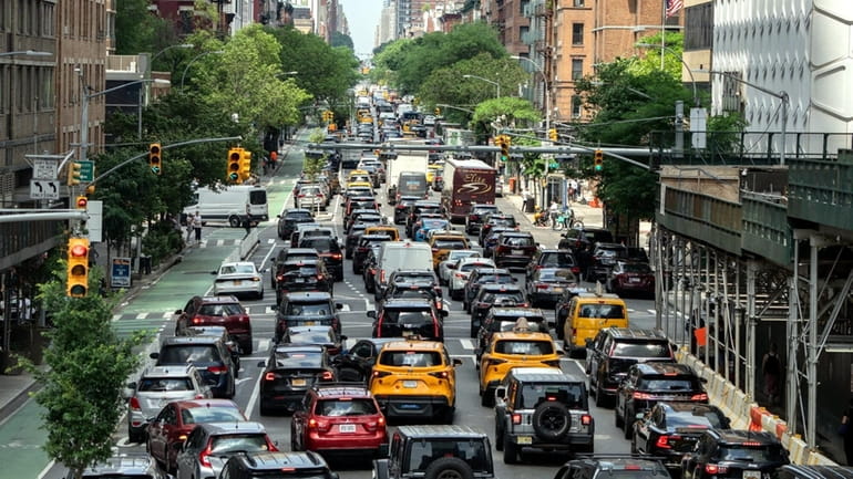Traffic is frozen on Tenth Avenue in a typical Manhattan...