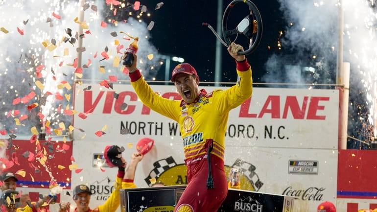 Joey Logano celebrates in Victory Lane after winning the NASCAR...