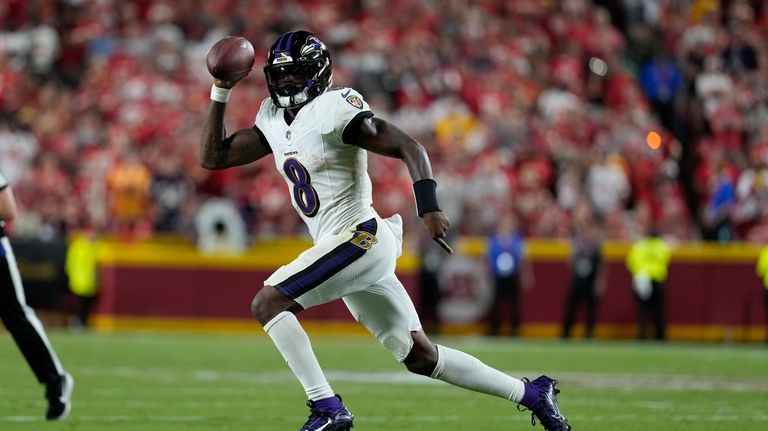 Baltimore Ravens quarterback Lamar Jackson runs with the ball during...