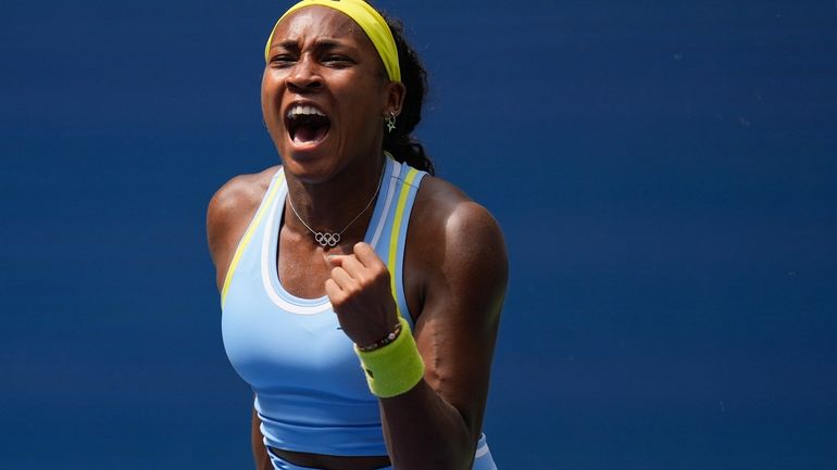 Coco Gauff, of the United States, reacts after scoring a...