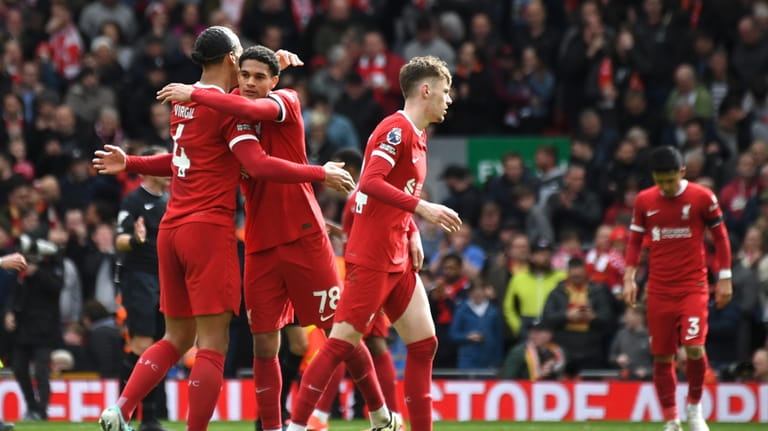 Liverpool's Virgil van Dijk, left, and Liverpool's Jarell Quansah celebrate...