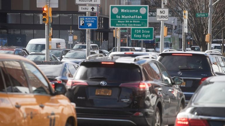 Vehicles arrive in Manhattan after crossing the Williamsburg Bridge on Tuesday,