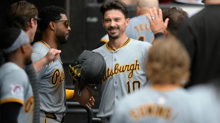 Pittsburgh Pirates' Bryan Reynolds celebrates with teammates in the dugout...