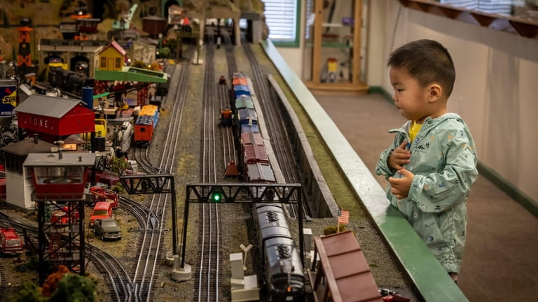 Tianyong Sun of Needham, Mass. plays with trains at the Railroad Museum of...