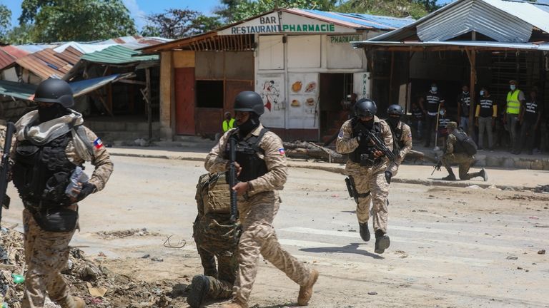 Haitian police patrol near the General Hospital after Haitian Prime...