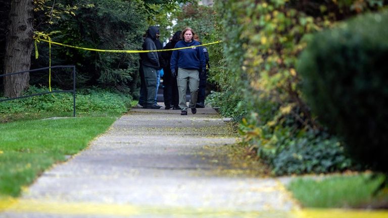 A law enforcement agent walks near the scene near the...