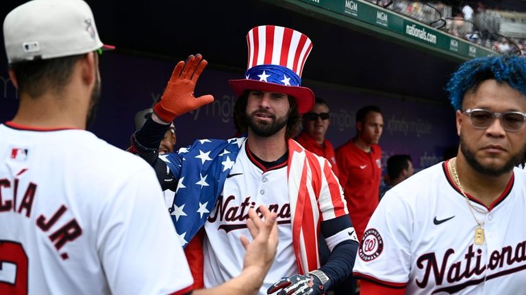 Washington Nationals' Jesse Winker, center, celebrates his home run with...