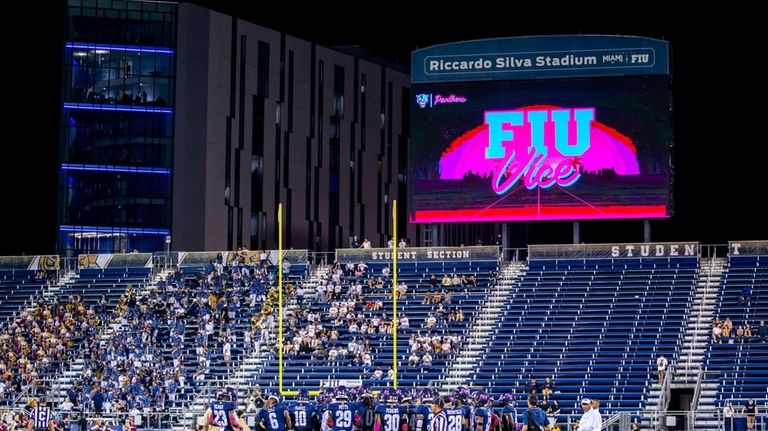 Florida International University football team huddles for a timeout during...