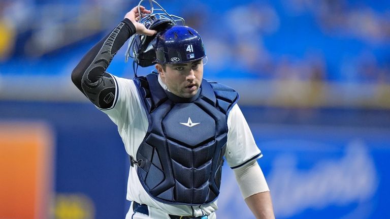 New Tampa Bay Rays catcher Logan Driscoll walks back to...