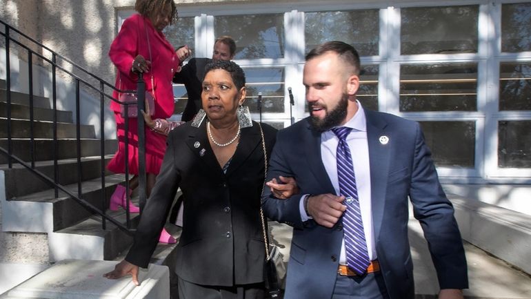 Tessie Prevost-Williams is escorted by U.S. Marshal Michael Atkins, as...