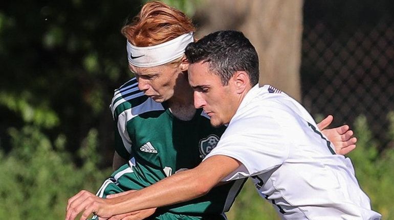 Tommy Browne, #10 of Carle Place, maneuvers the ball away...