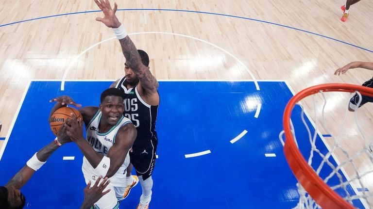 Minnesota Timberwolves guard Anthony Edwards goes up for a shot...