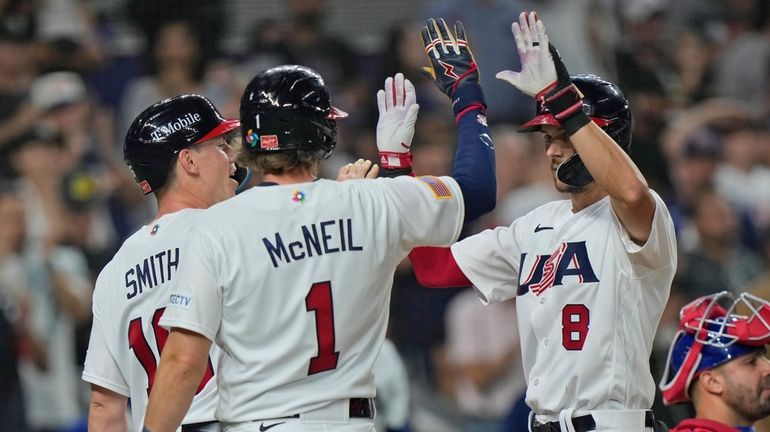 United States' Trea Turner (8) celebrates at home plate after...