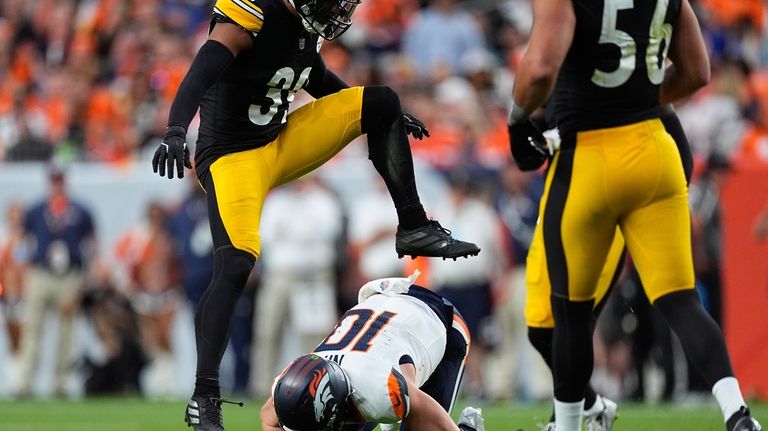 Denver Broncos quarterback Bo Nix (10) falls after a short...