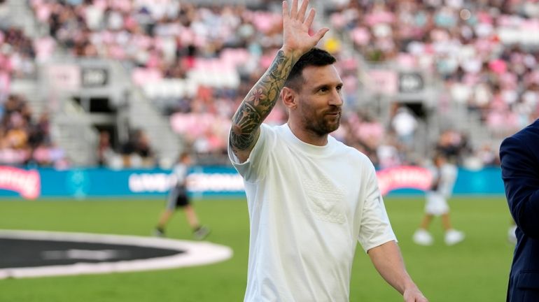 Inter Miami forward Lionel Messi waves as he walks off...