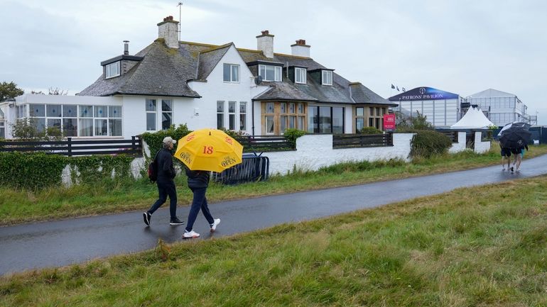 Spectators walk past "Blackrock house" that is listed for sale...