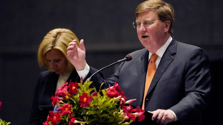 Mississippi's Republican Gov. Tate Reeves offers a prayer during a...