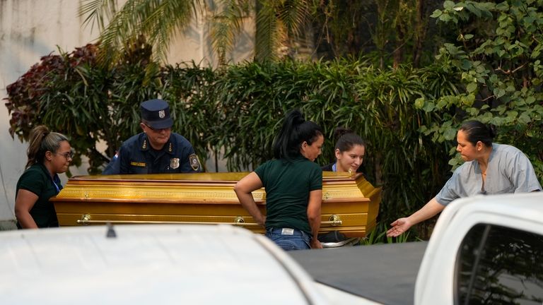 Police bring the remains of lawmaker Eulalio "Lalo" Gomez to...