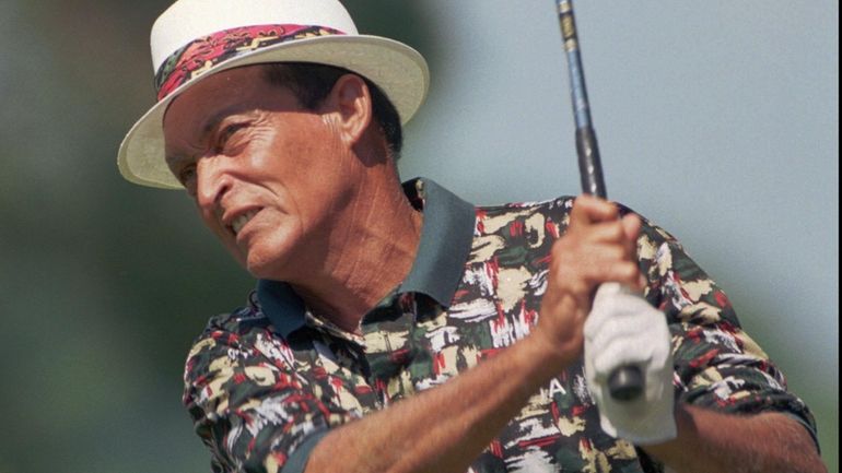 Chi Chi Rodriguez watches his drive on the 15th hole...