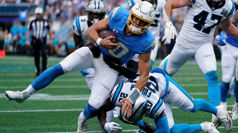 Los Angeles Chargers quarterback Justin Herbert runs against the Carolina...