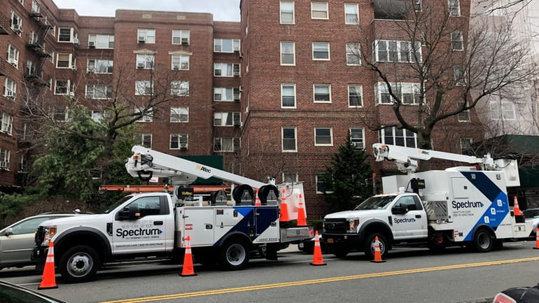 Spectrum maintenance trucks at an apartment building in Queens. A federal pandemic-era subsidy for lower-income...
