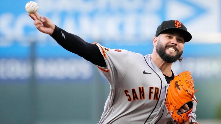 FILE -San Francisco Giants relief pitcher Jakob Junis throws to...