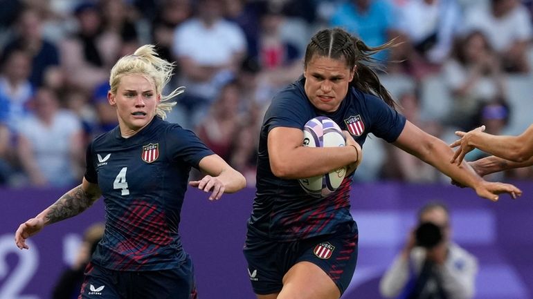 United States' Ilona Maher, fends off the tackle of Brazil's...