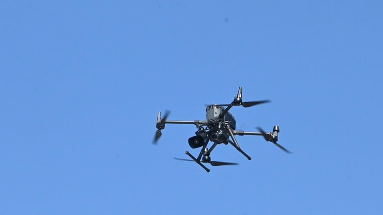 Authorities use a drone to search for sharks after a shark...