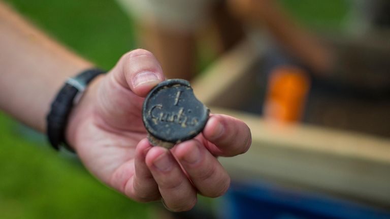 Jack Gary, Colonial Williamsburg’s executive director of archaeology, holds the...