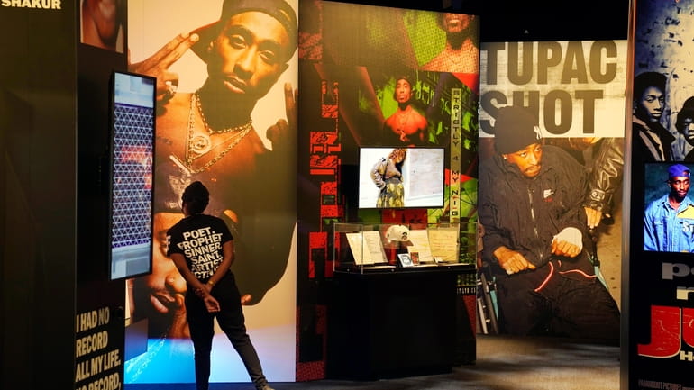 A visitor observes a display of late hip hop artist...