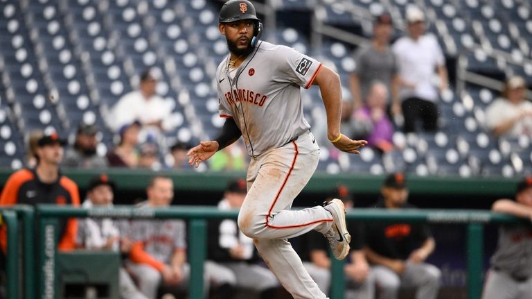 San Francisco Giants' Jerar Encarnacion runs toward home to score...