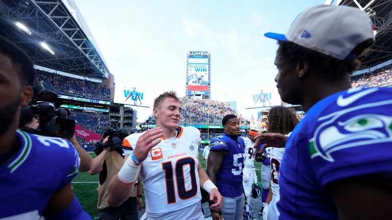 Denver Broncos quarterback Bo Nix (10) greets Seattle Seahawks quarterback...