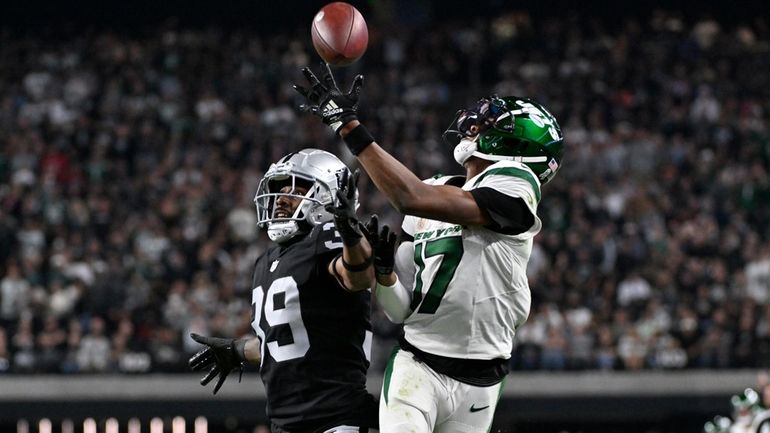 Las Vegas Raiders cornerback Nate Hobbs, left, breaks up a...